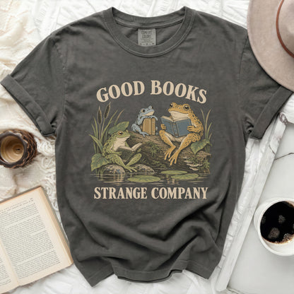 Dark grey t-shirt with a graphic of three frogs reading books with text "GOOD BOOKS STRANGE COMPANY".