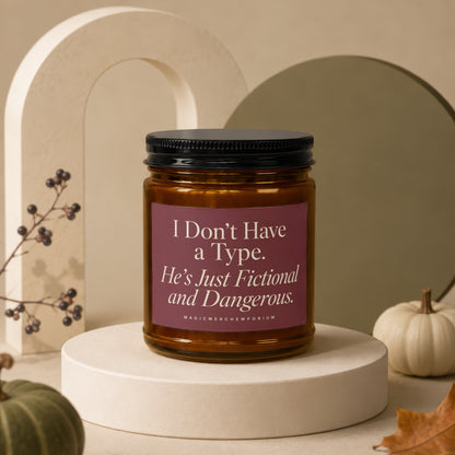 Amber candle with black lid reads "I Don't Have a Type. He's Just Fictional and Dangerous."