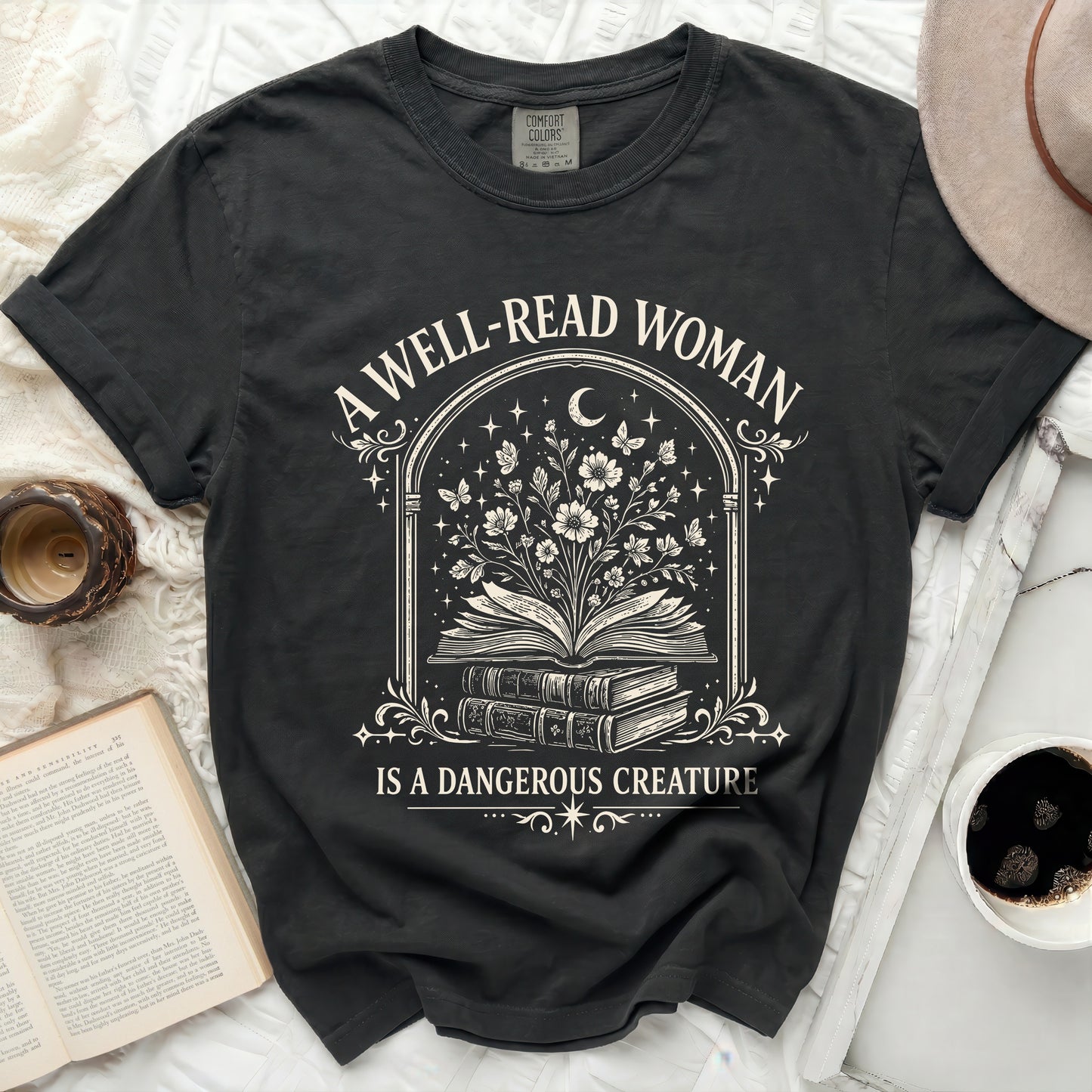 Black t-shirt with "A well-read woman is a dangerous creature" text and floral book graphic.