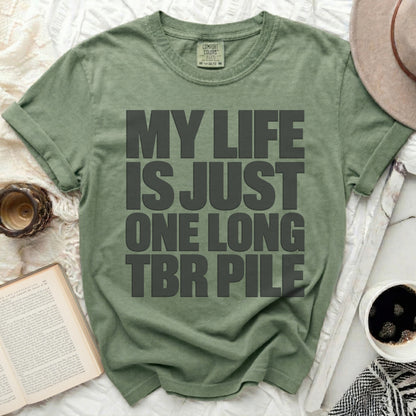 Green t-shirt with gray text: "MY LIFE IS JUST ONE LONG TBR PILE."