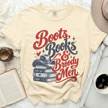 Boots, Books & Broody Men graphic on a cream t-shirt.