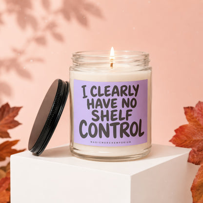 Candle with text "I CLEARLY HAVE NO SHELF CONTROL" on lavender label.