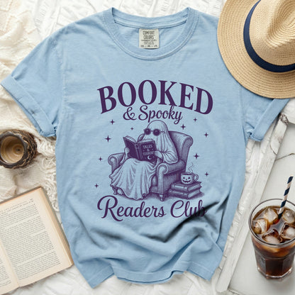 Light blue t-shirt with purple ghost reading and "Booked & Spooky Readers Club" text.