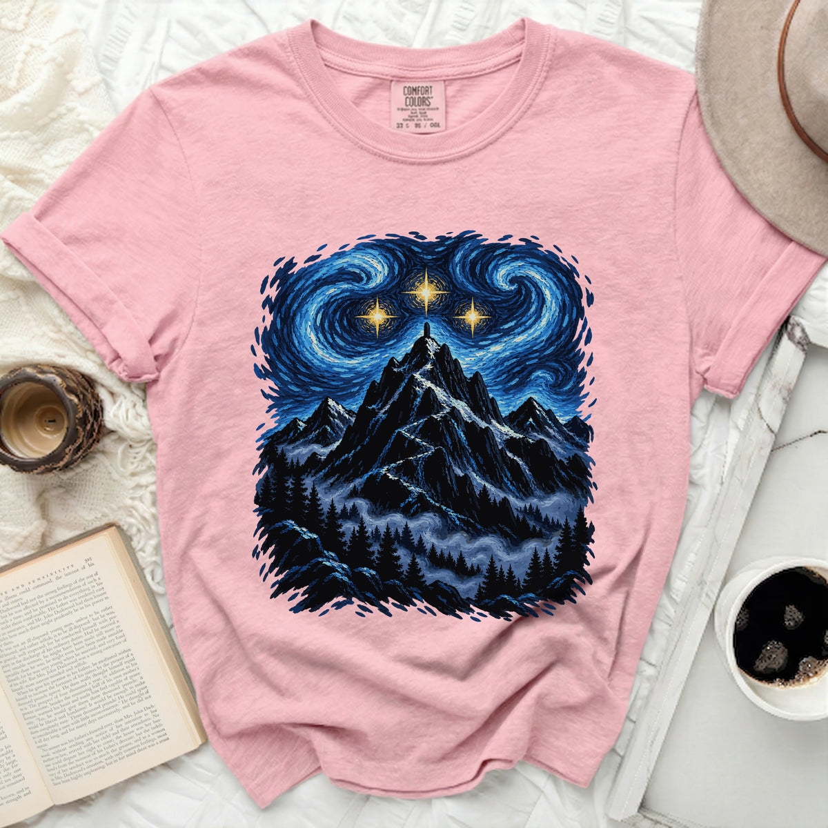 Pink Comfort Colors t-shirt with a mountain, trees, and starry night graphic.