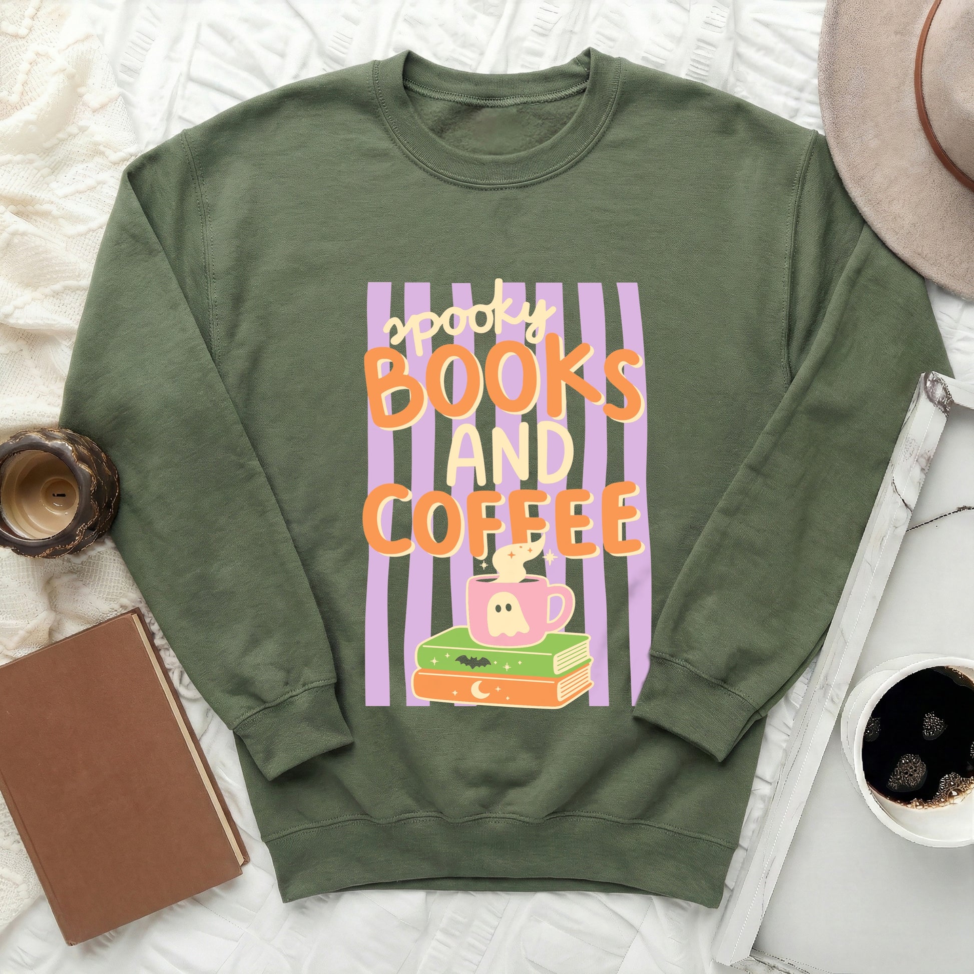 Green sweatshirt with "spooky books and coffee" text and Halloween graphics.