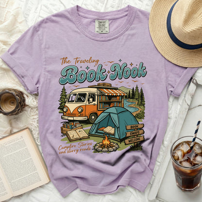 Purple t-shirt with "The Traveling Book Nook" graphic, featuring a van, tent, and campfire.