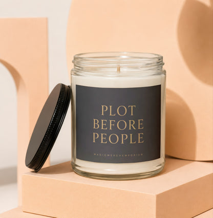 Glass jar candle with black label reading "PLOT BEFORE PEOPLE".