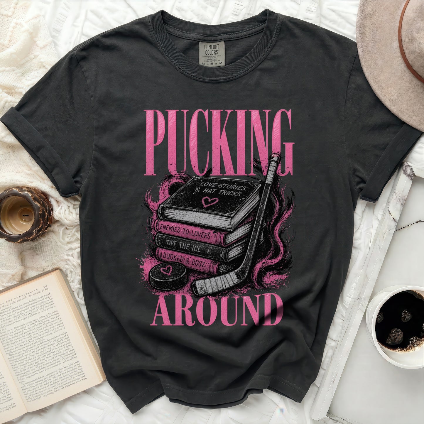 T-shirt with "Pucking" text and hockey puck over books.