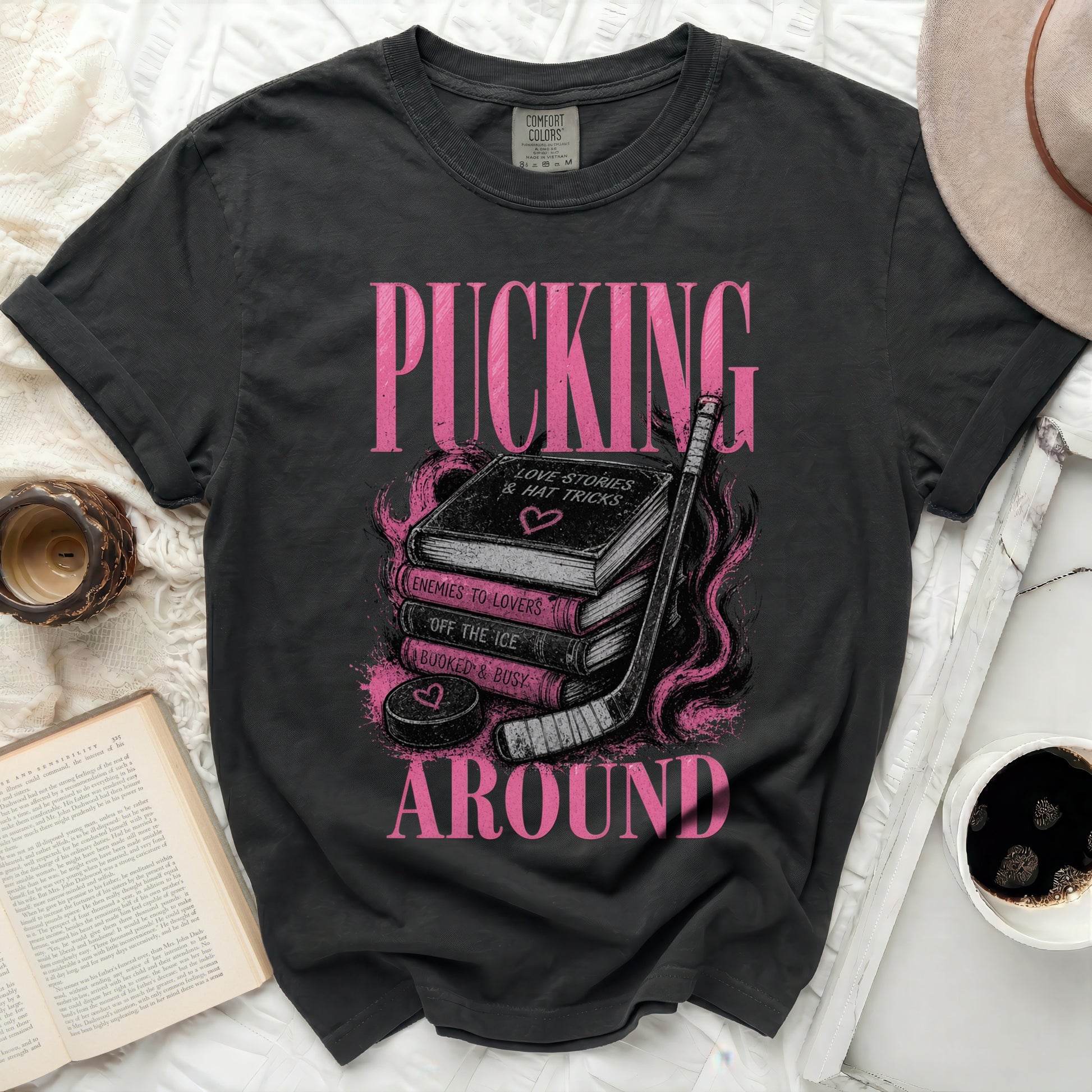T-shirt with "Pucking" text and hockey puck over books.