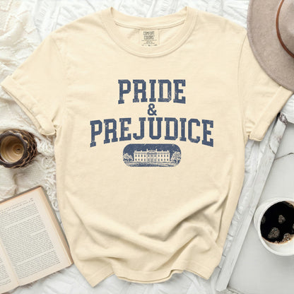 Cream Comfort Colors t-shirt with "Pride & Prejudice" and a building graphic.