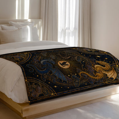 Blue and gold dragons adorn a dark blue celestial pattern blanket on a bed.