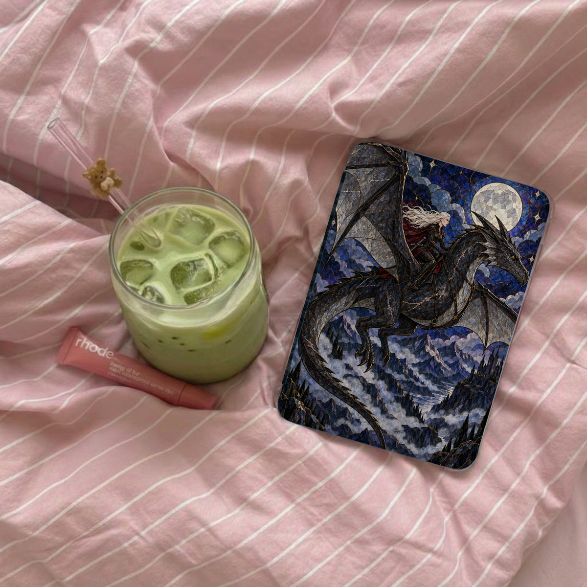 Phone case with dragon rider and castle illustration on pink striped background.
