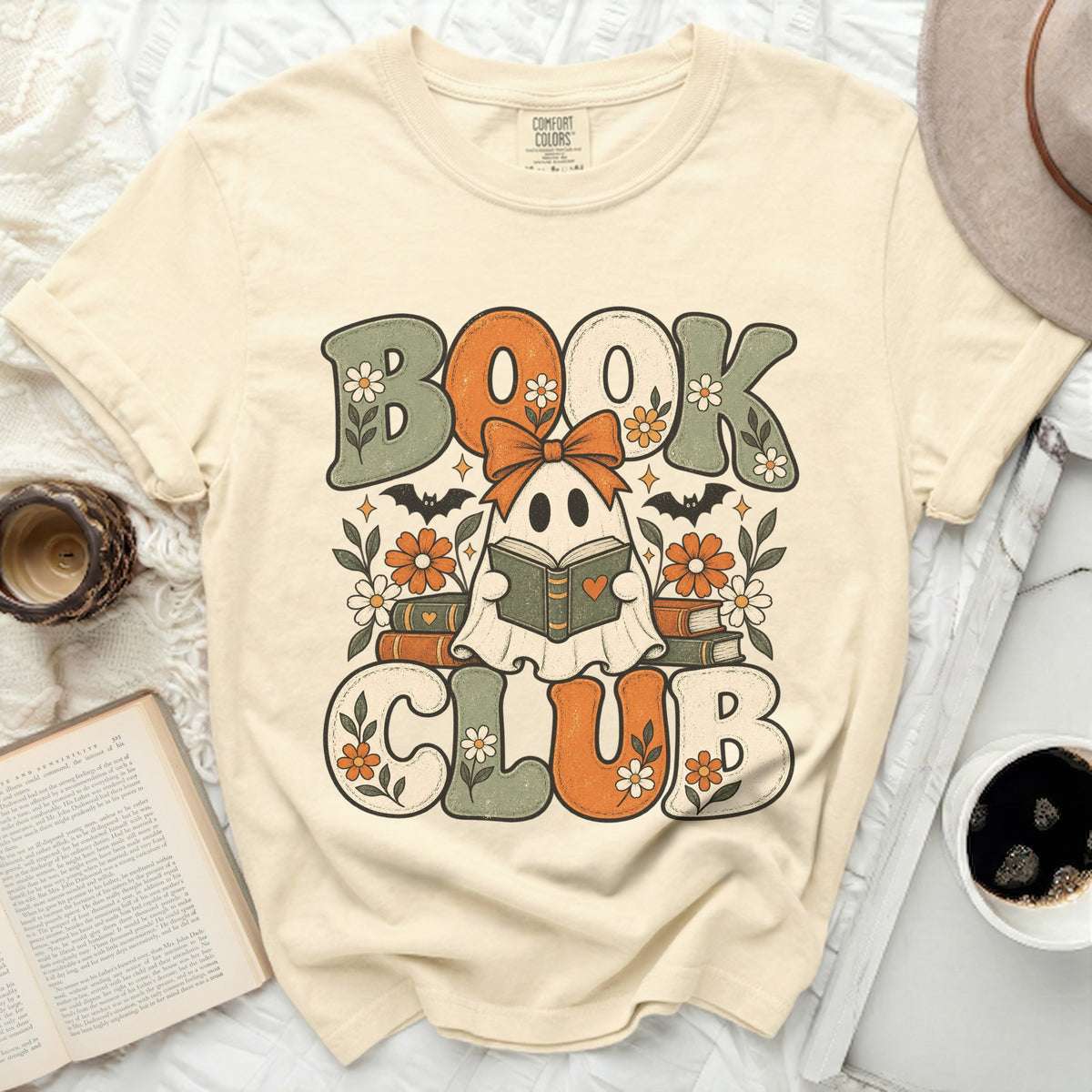 Ghost reading a book with text "BOOK CLUB" on a cream t-shirt.