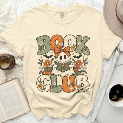 Ghost reading a book with text "BOOK CLUB" on a cream t-shirt.