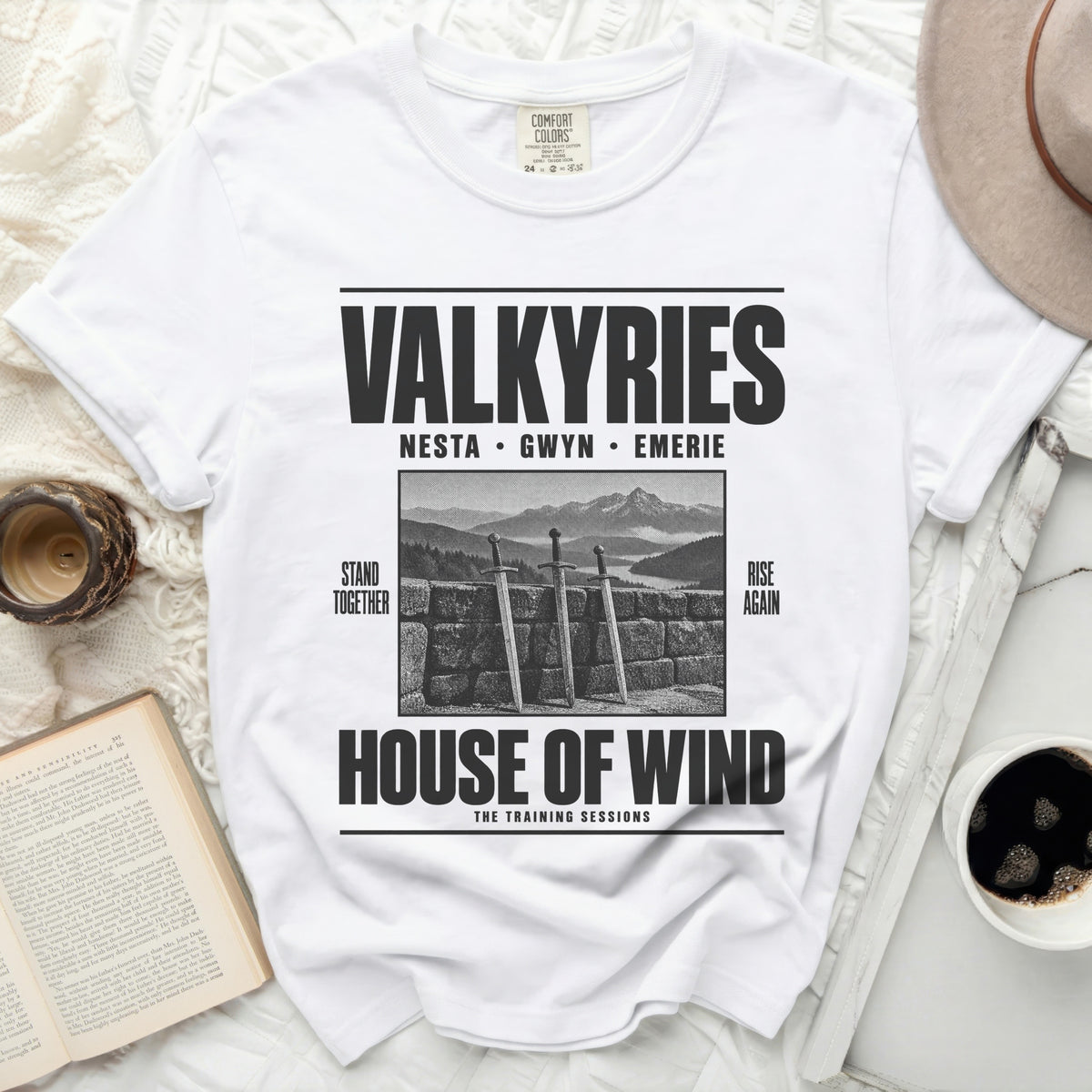 White t-shirt with "VALKYRIES" and "HOUSE OF WIND" text, swords graphic.