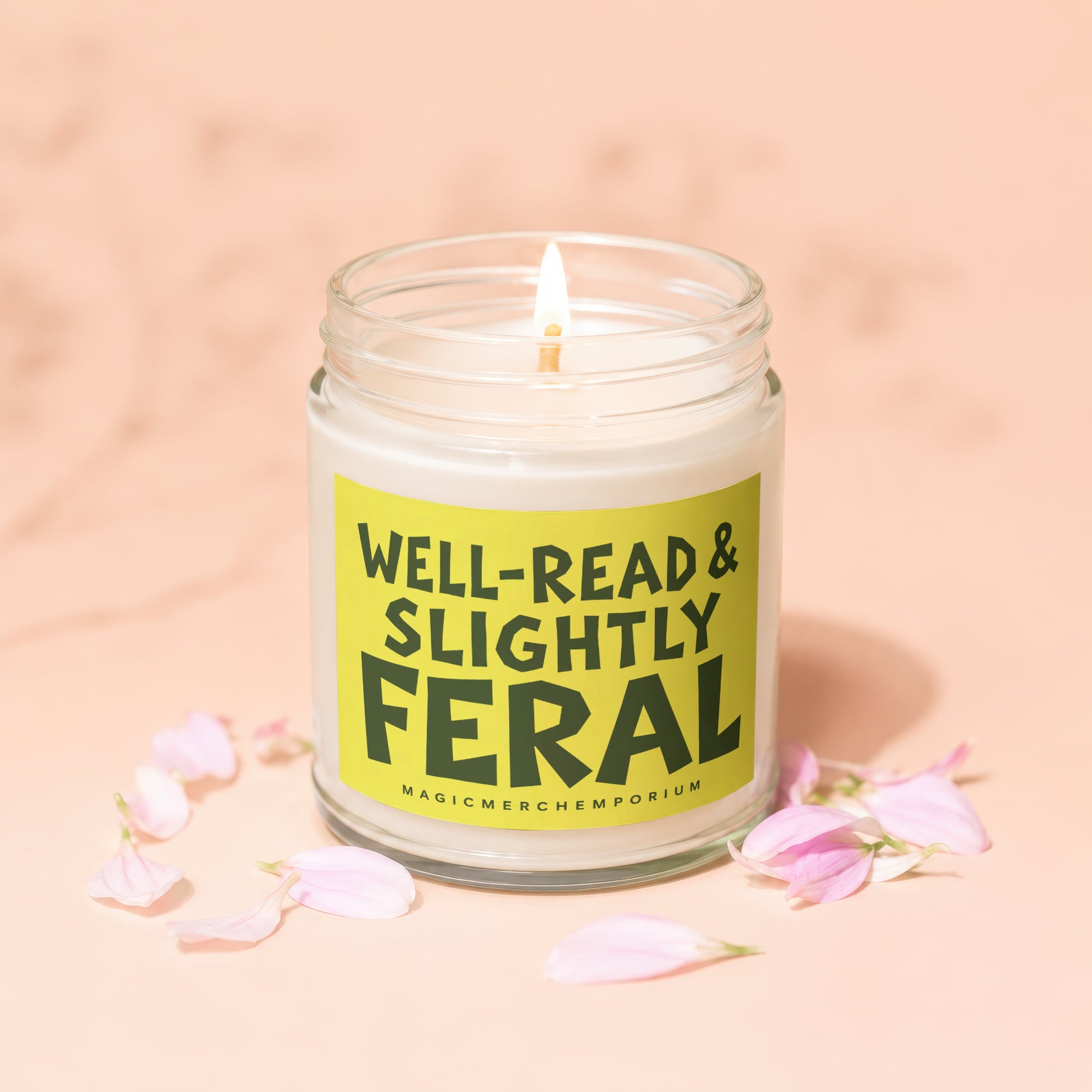 Jar candle with a lit wick, labeled "Well-Read & Slightly Feral".