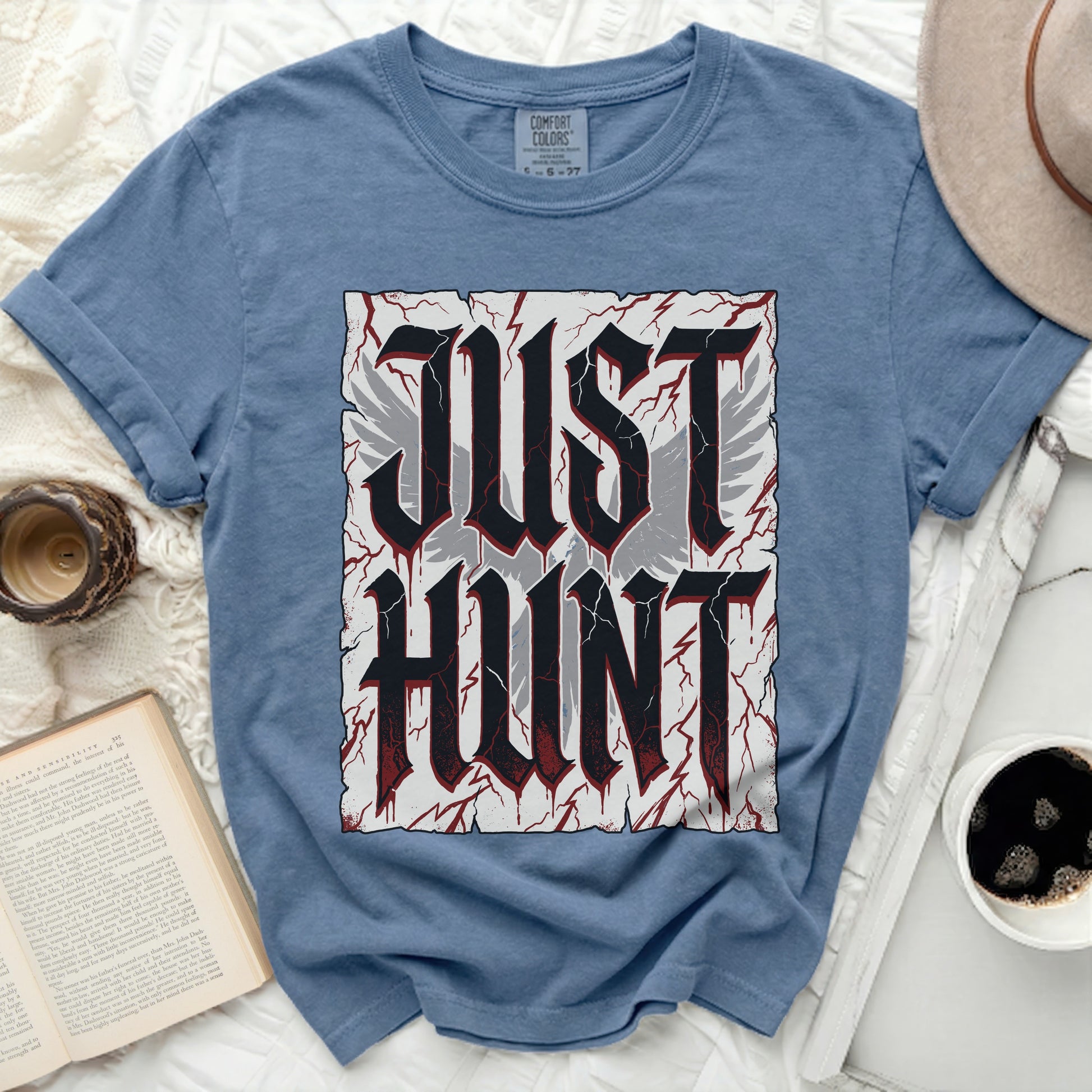 Blue t-shirt with "JUST HUNT" in bold gothic font and wing graphics.