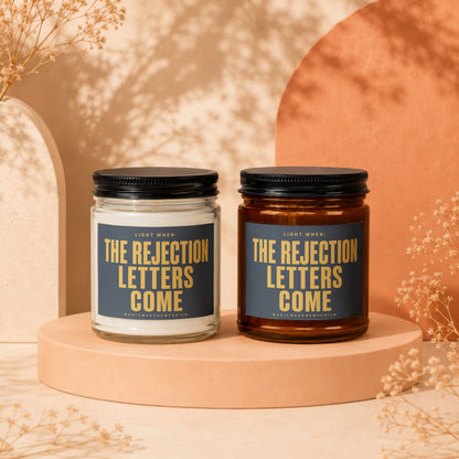 Two candles with labels reading "The Rejection Letters Come".