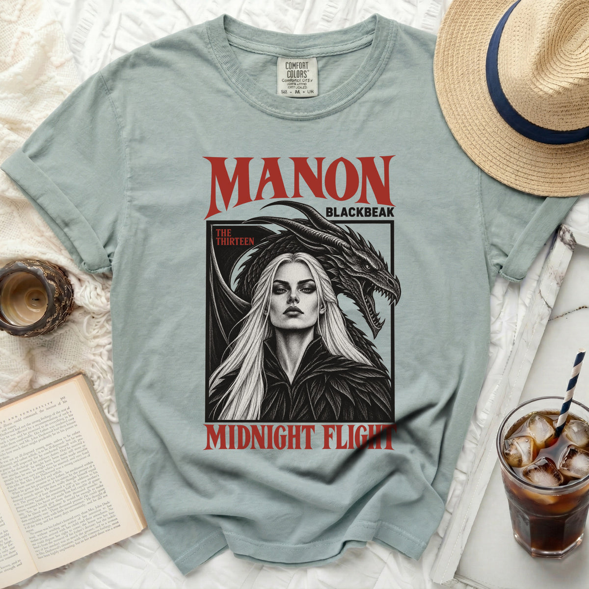 Light blue t-shirt with "MANON BLACKBEAK MIDNIGHT FLIGHT" graphic.