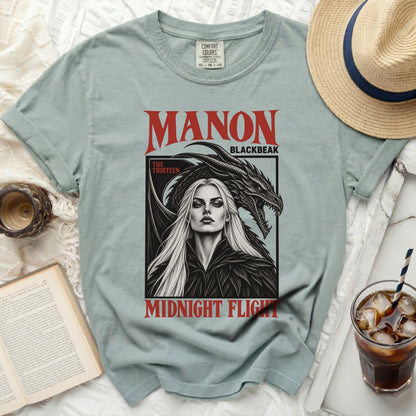 Light blue t-shirt with "MANON BLACKBEAK MIDNIGHT FLIGHT" graphic.