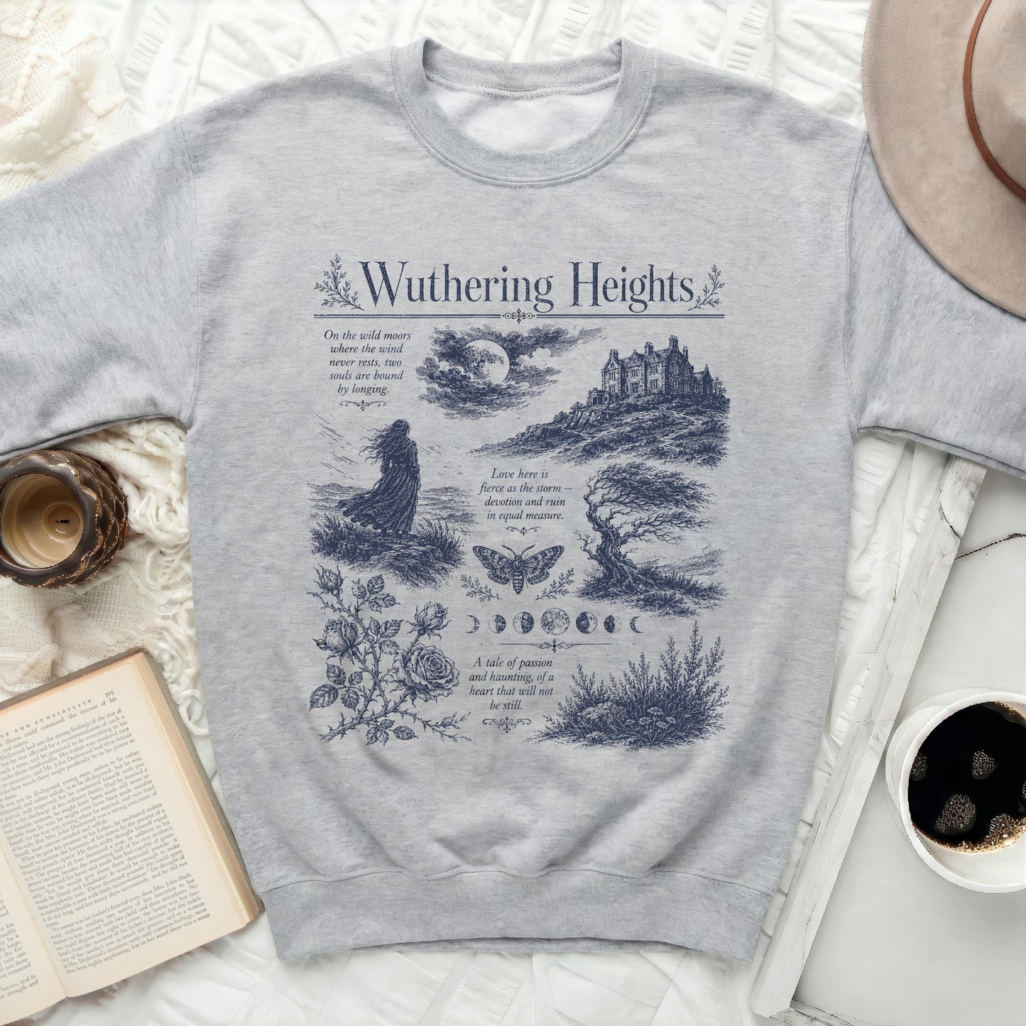 Gray sweatshirt with Wuthering Heights graphic featuring text, castle, moon, and figures.
