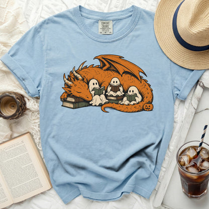 Light blue t-shirt featuring an orange dragon sleeping with three ghosts reading books.