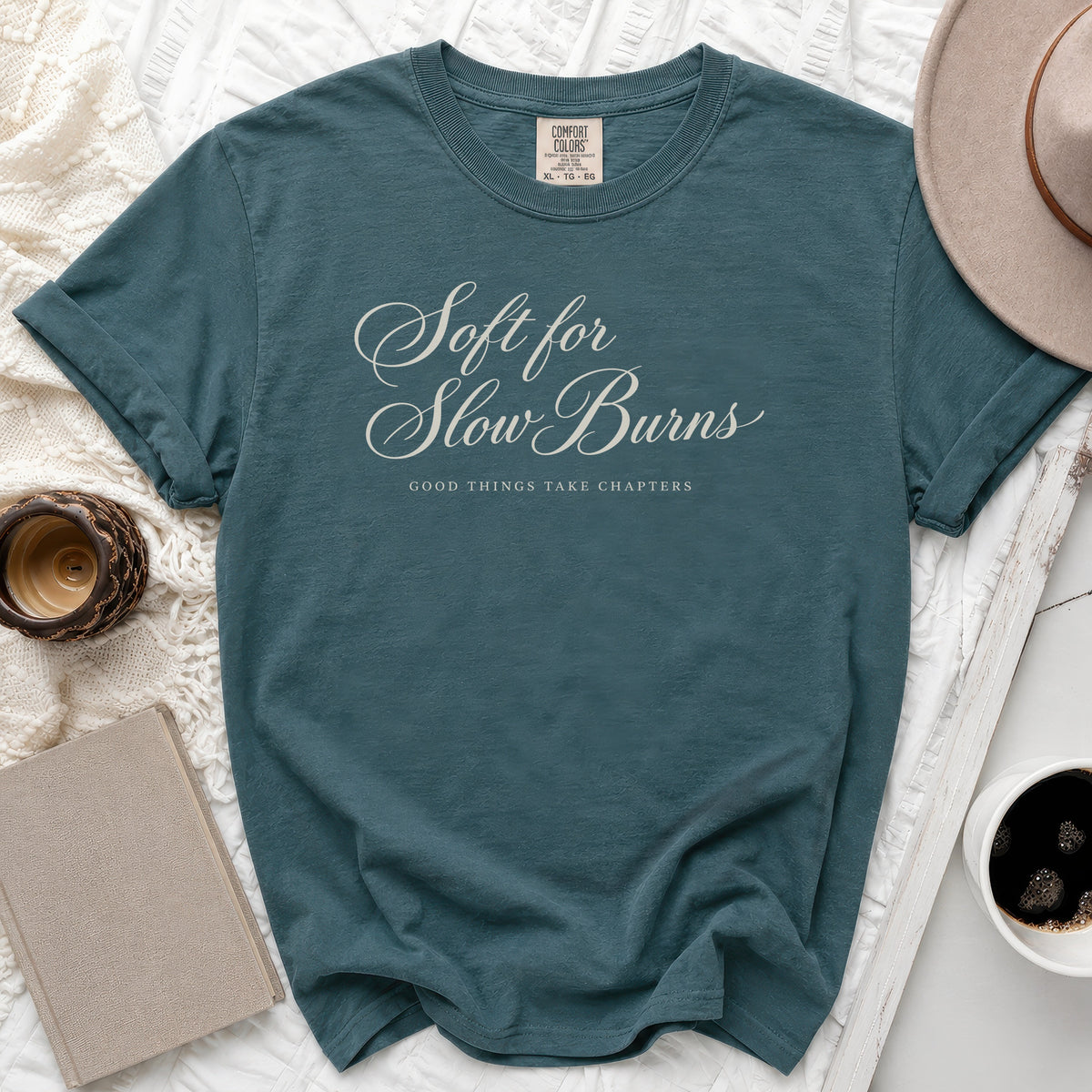 Teal t-shirt with "Soft for Slow Burns, Good Things Take Chapters" text.