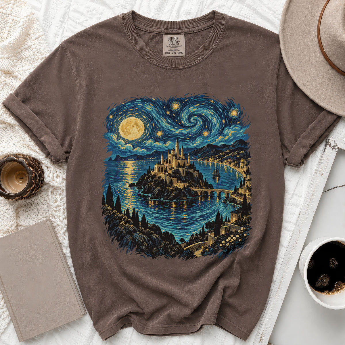 Brown t-shirt with a castle by the sea under a starry night sky.