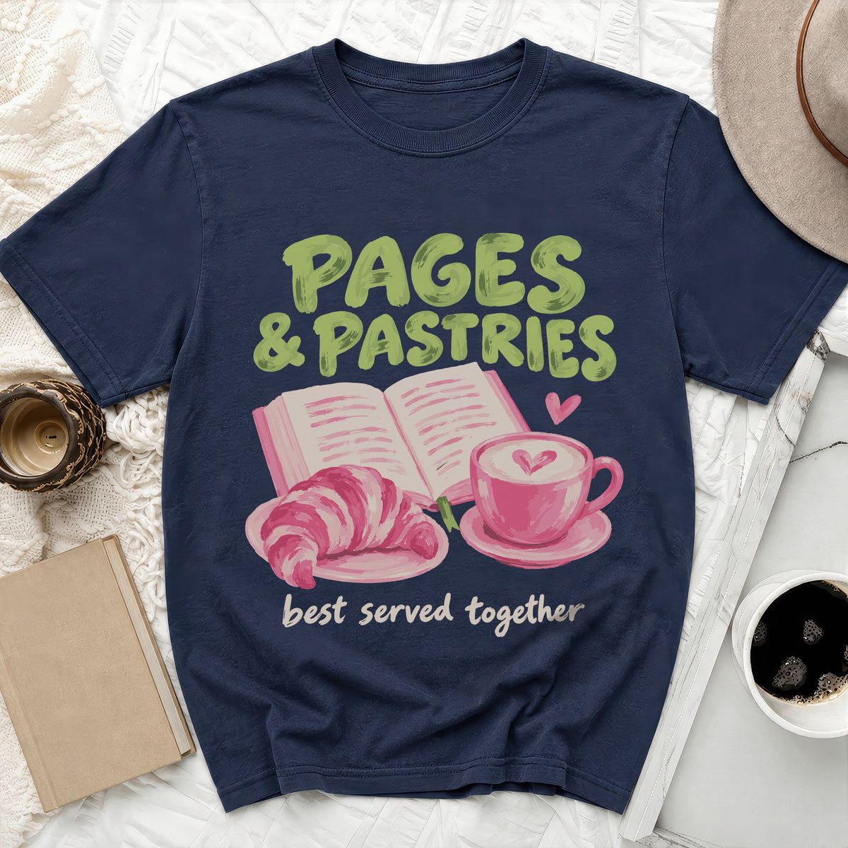 Navy t-shirt with "Pages & Pastries best served together" text and book, croissant, and coffee.