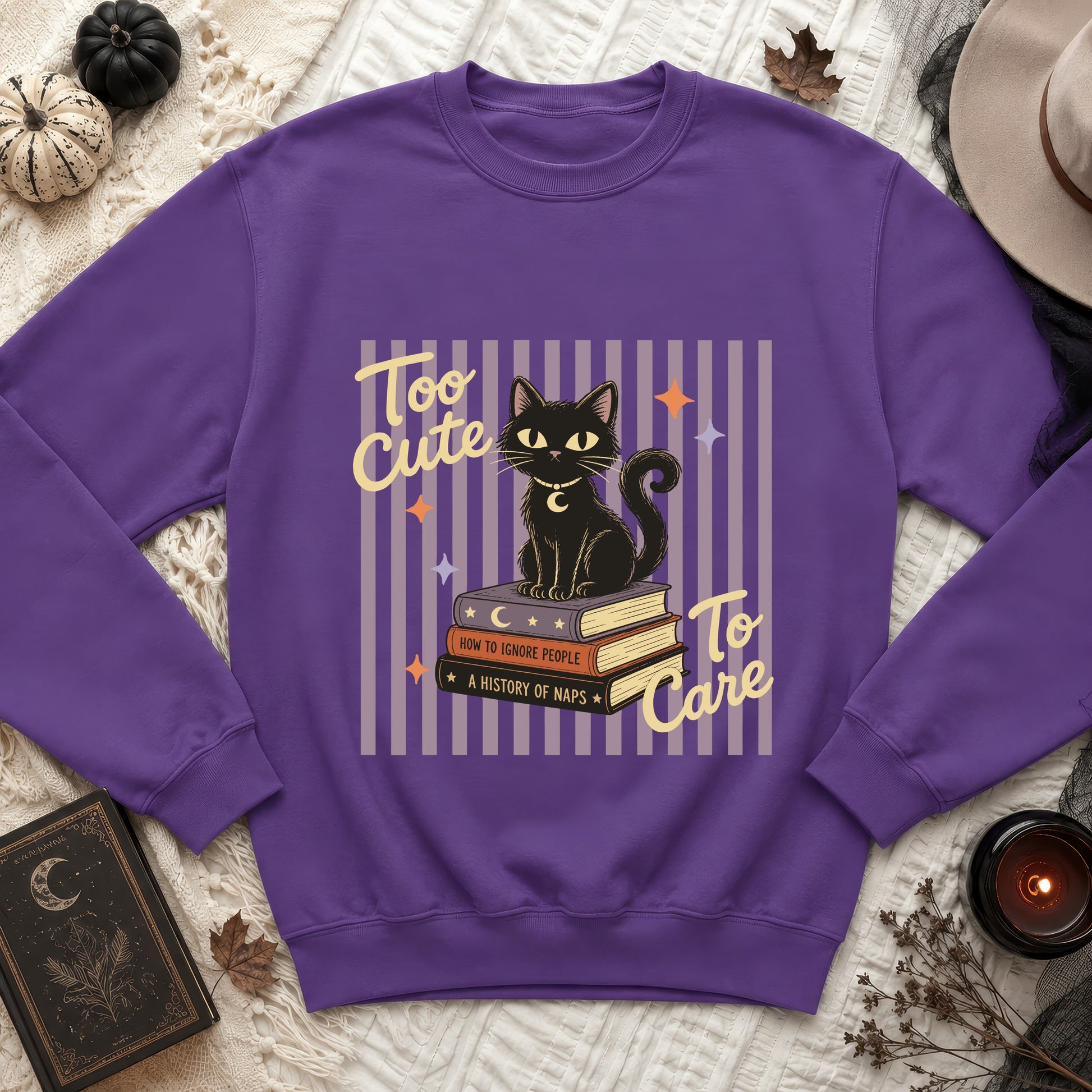 Purple sweatshirt with black cat on books reading "Too Cute To Care".