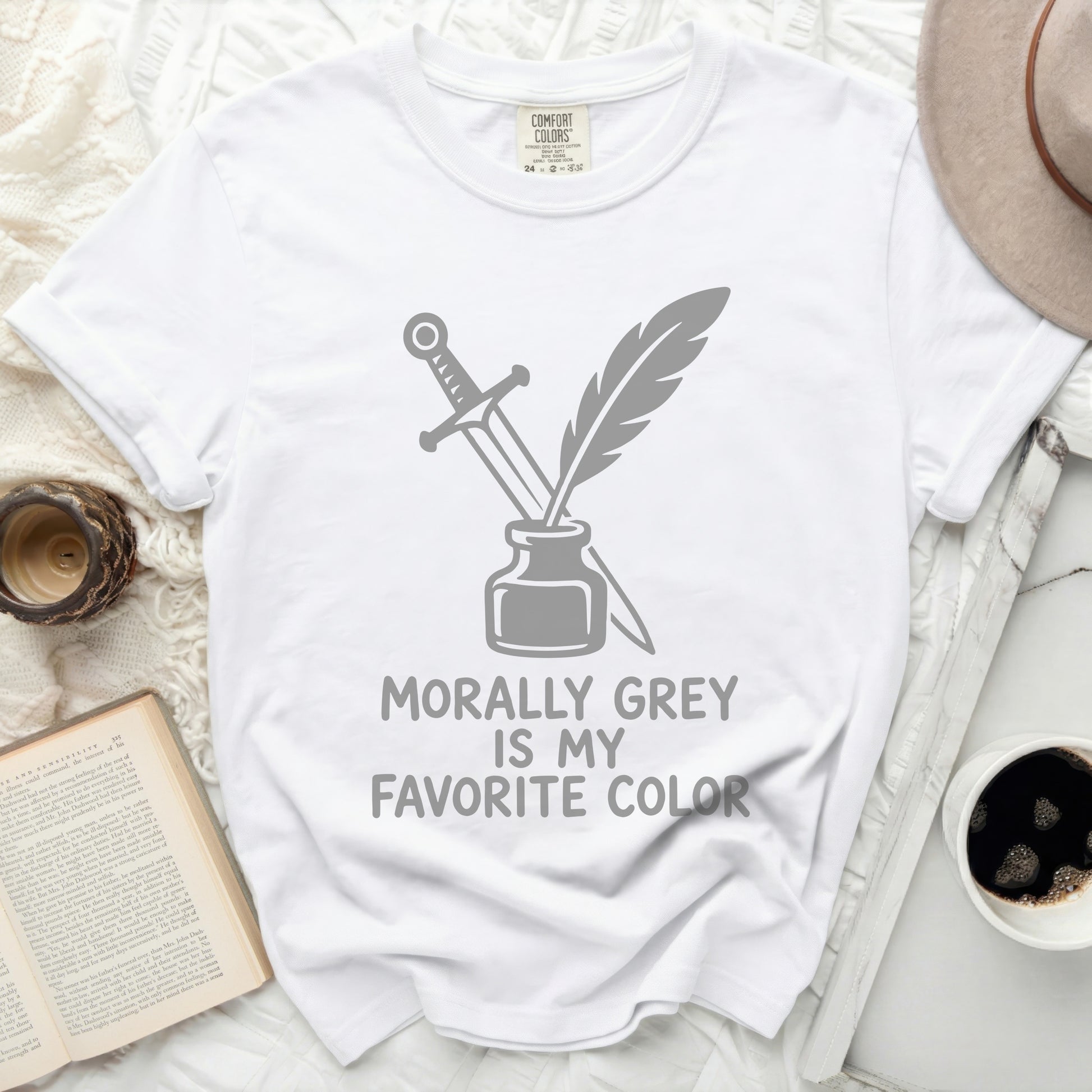 White t-shirt with "Morally Grey Is My Favorite Color" text and quill and dagger graphic.