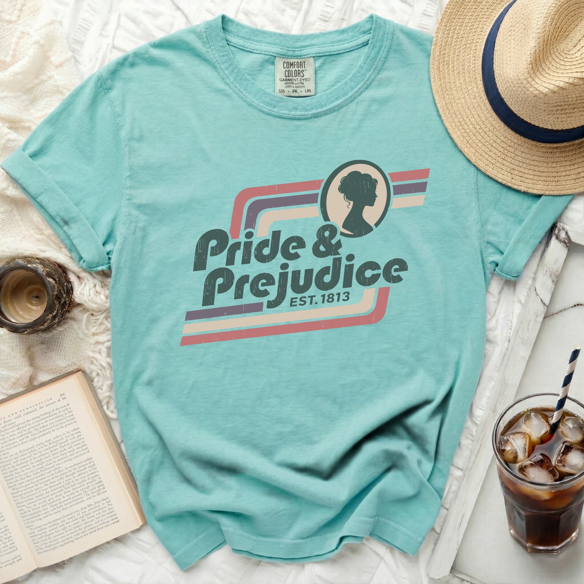 Teal t-shirt with "Pride & Prejudice EST. 1813" text and silhouette.