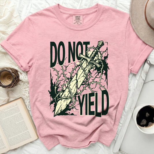 Pink t-shirt with a sword and thorns graphic that reads "DO NOT YIELD".