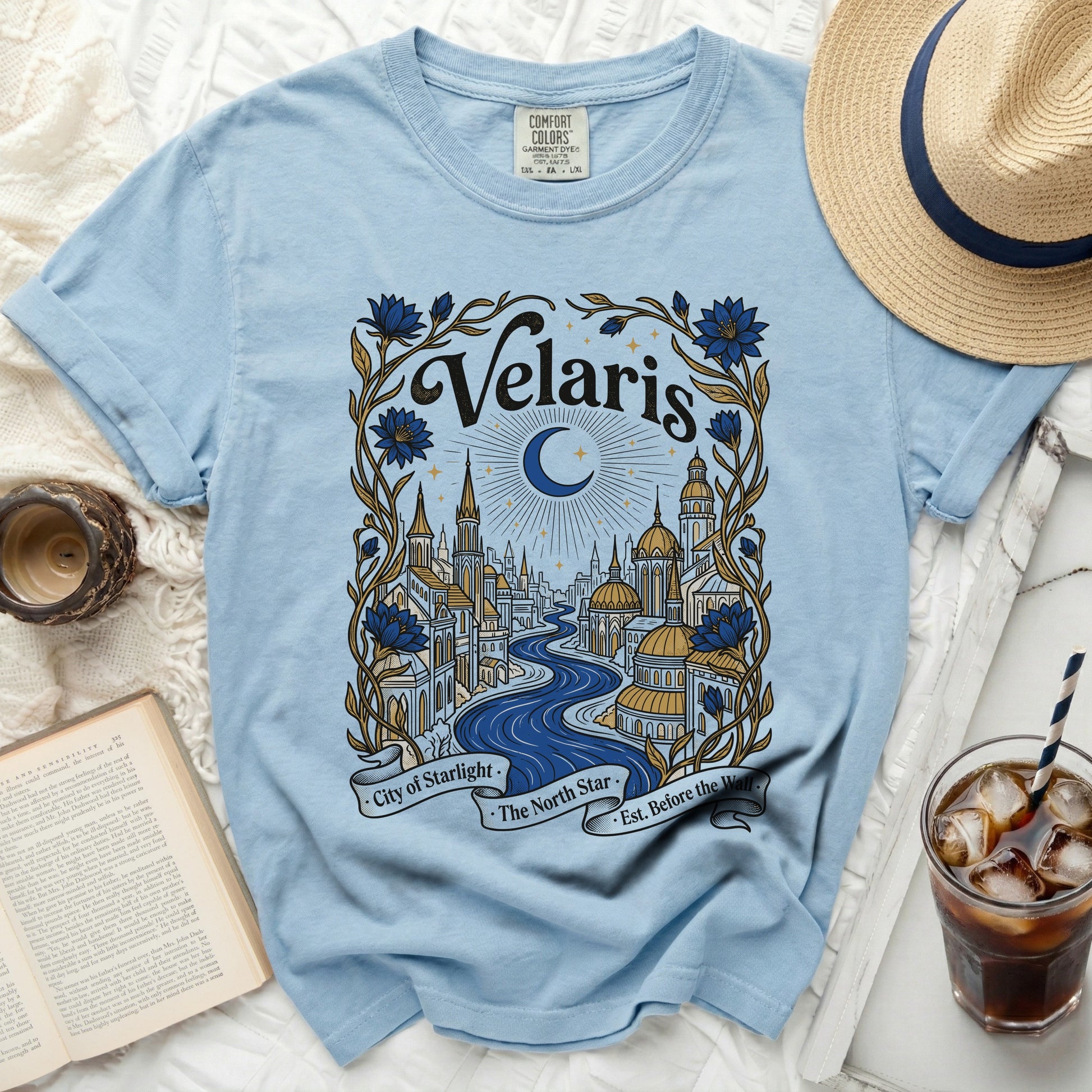 Light blue t-shirt with "Velaris City of Starlight" and city skyline art.