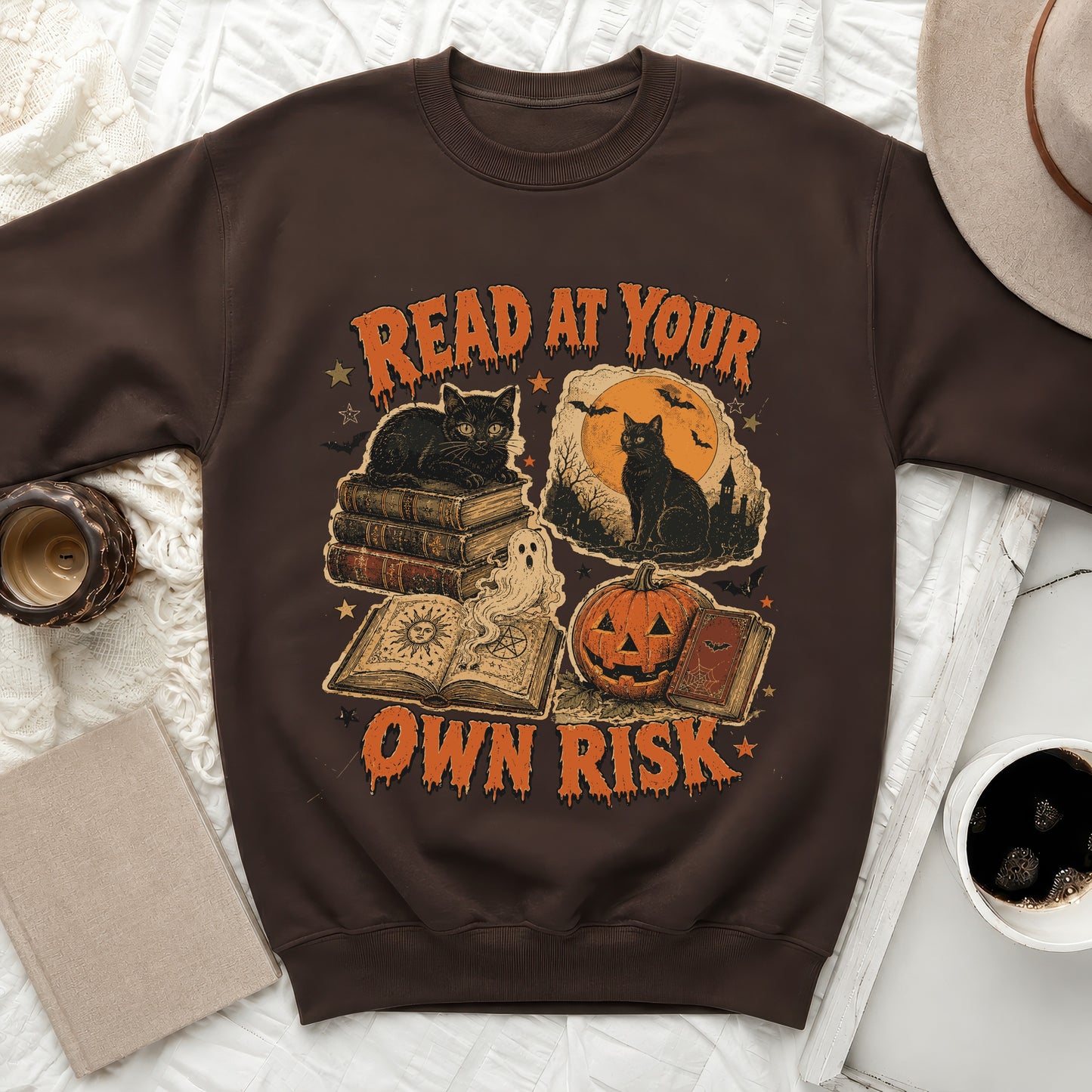 Dark brown sweatshirt with Halloween graphic: black cats, books, pumpkin, ghost, and text.