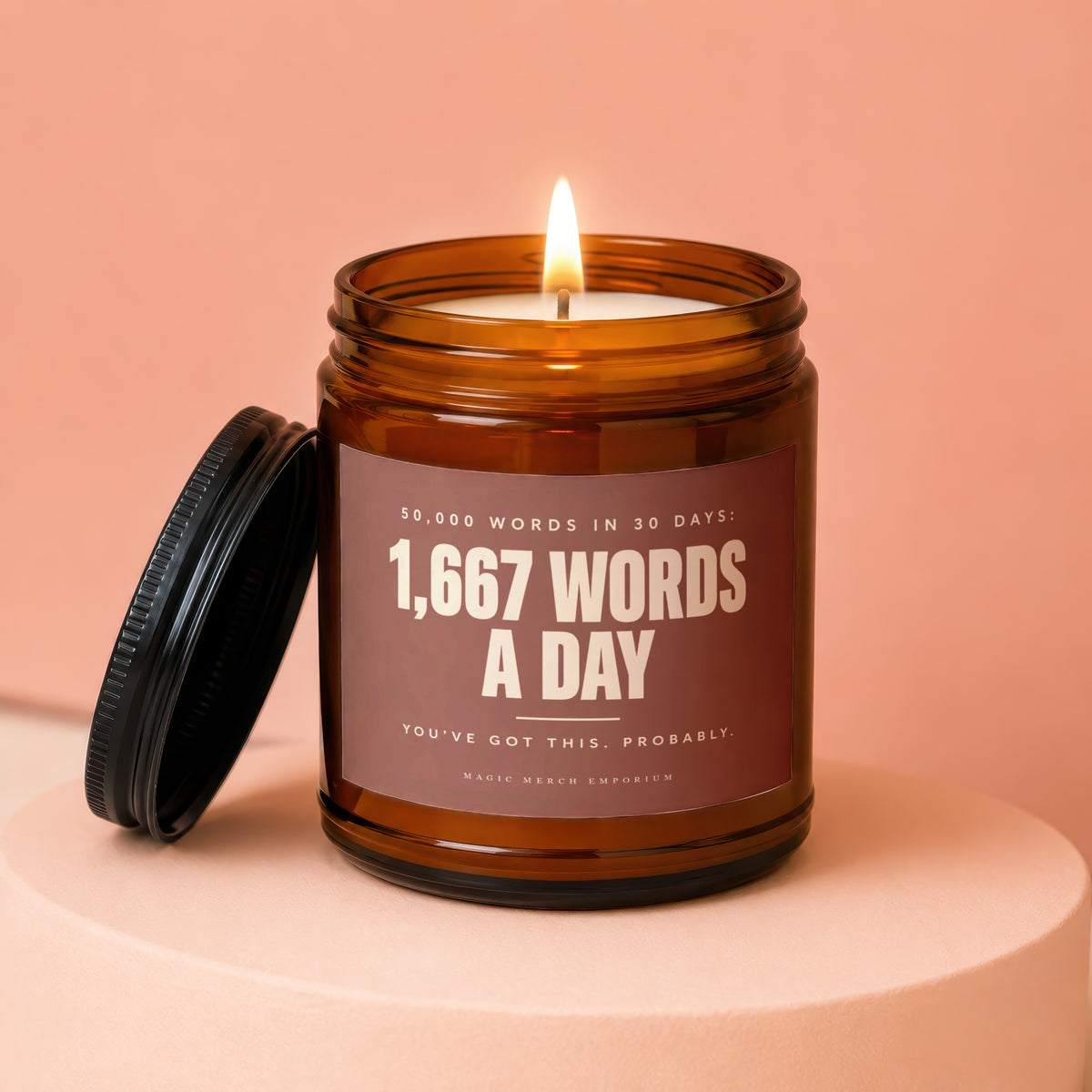Amber jar candle with lit flame, labeled "1,667 Words A Day."