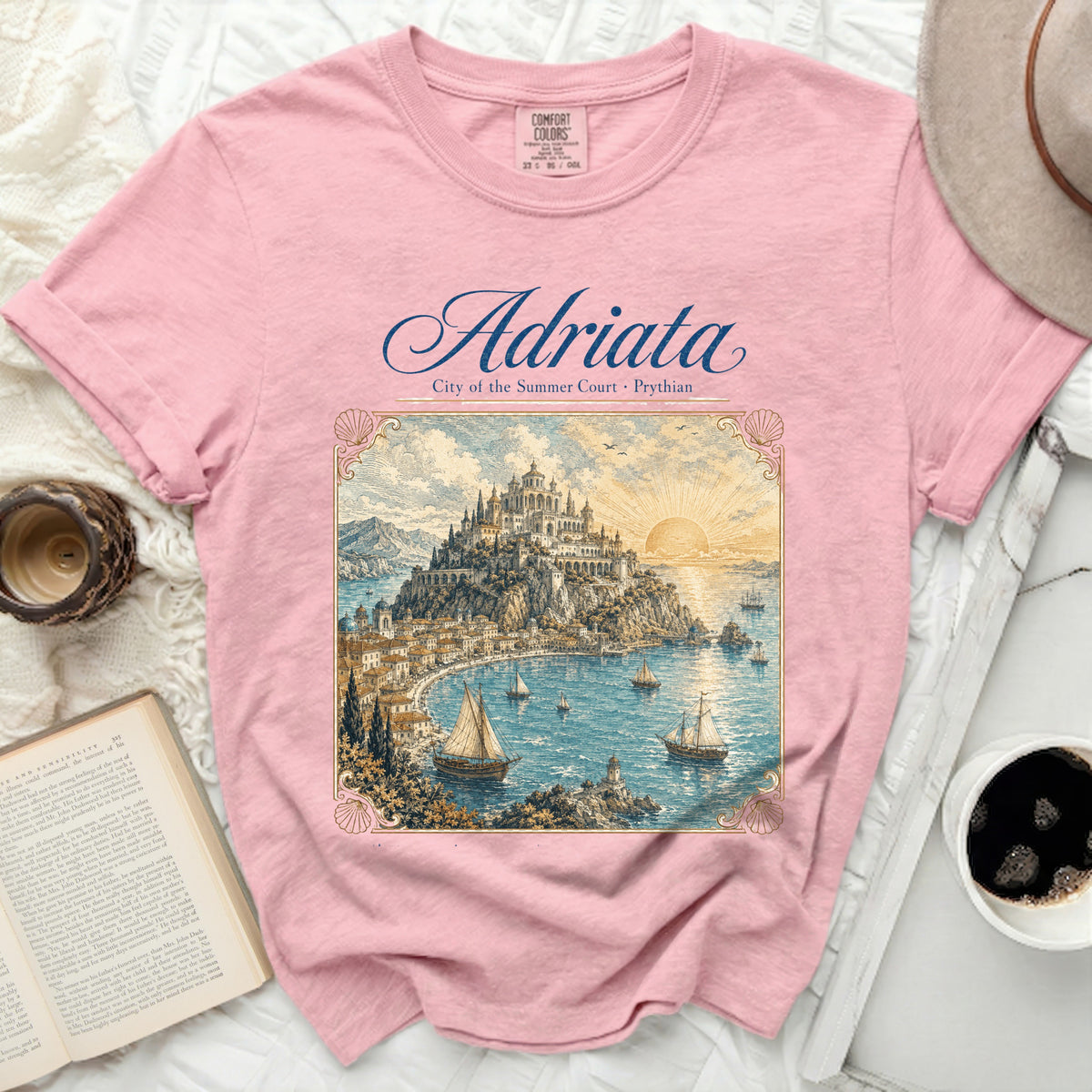 Pink t-shirt with "Adriata City of the Summer Court · Phyrian" text and vintage coastal castle art.
