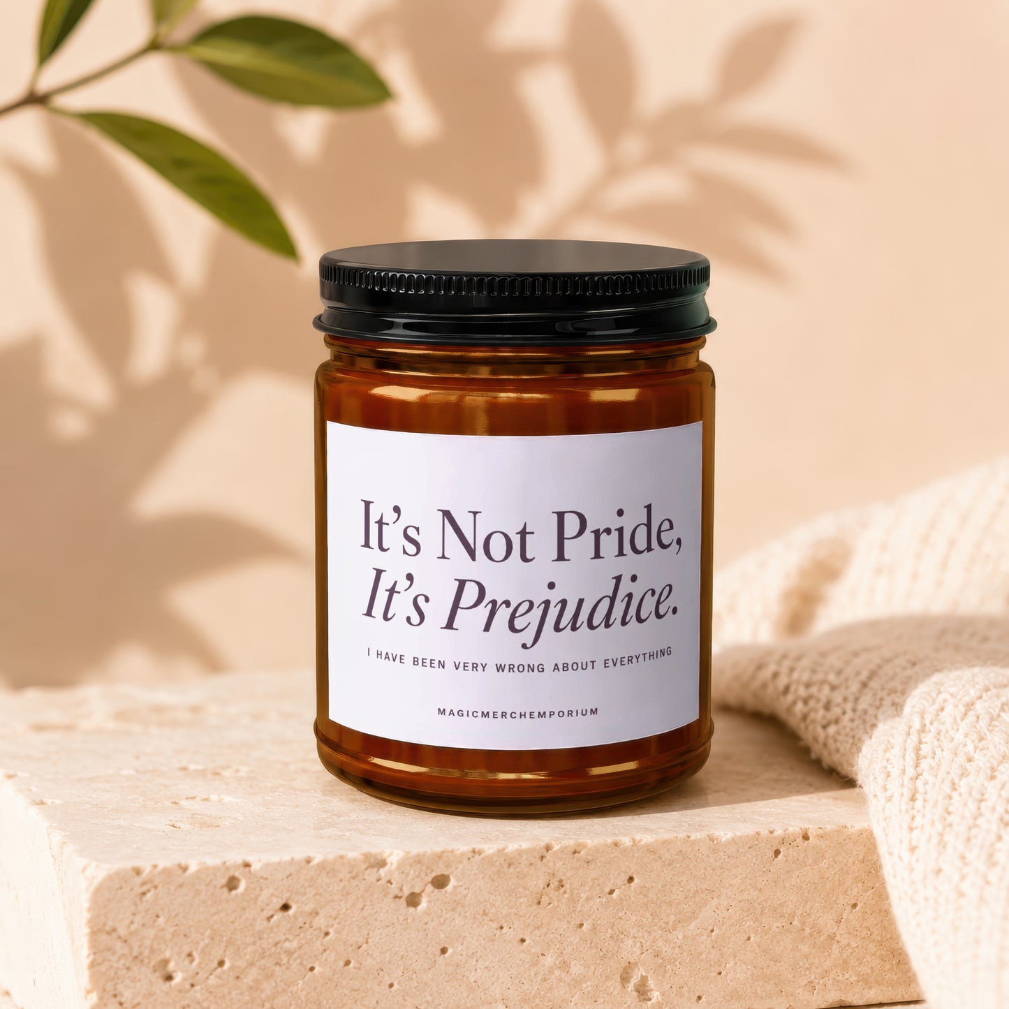 Amber candle with black lid featuring "It's Not Pride, It's Prejudice" quote.