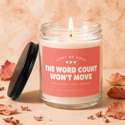 Candle with text "The Word Count Won't Move" and a lit wick.