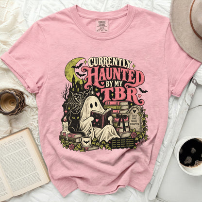 Pink t-shirt with "Currently Haunted By My TBR" graphic of a ghost reading.
