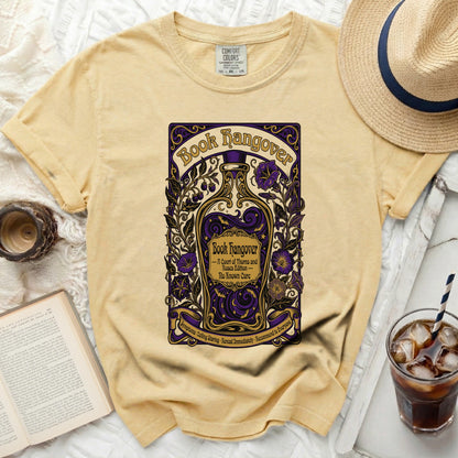 Yellow t-shirt with "Book Hangover" graphic featuring a bottle and floral design.