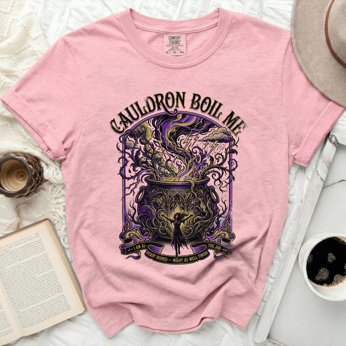 Pink t-shirt with a graphic featuring a cauldron, lightning, and the text "CAULDRON BOIL ME".