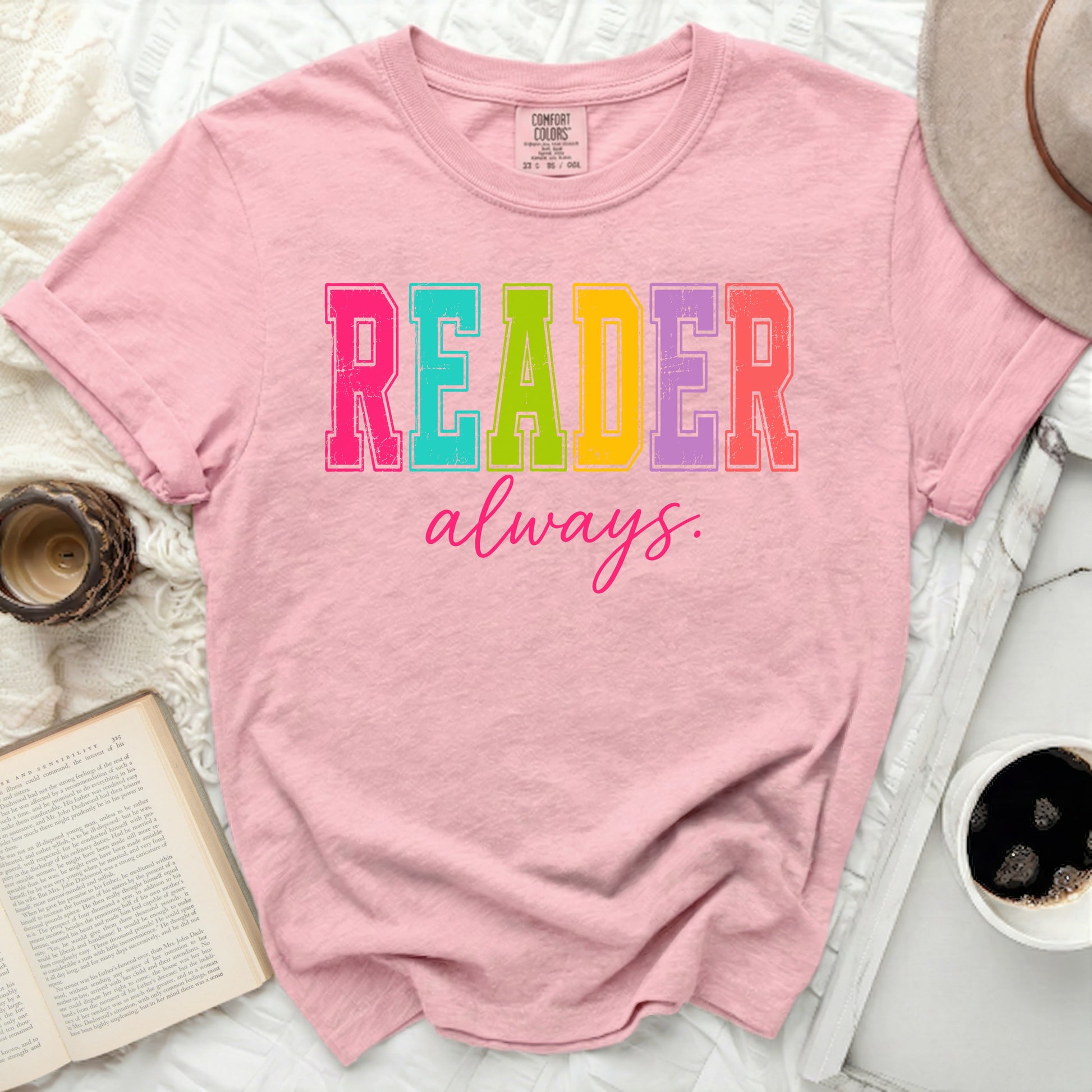Pink t-shirt with "READER always" in colorful block letters.
