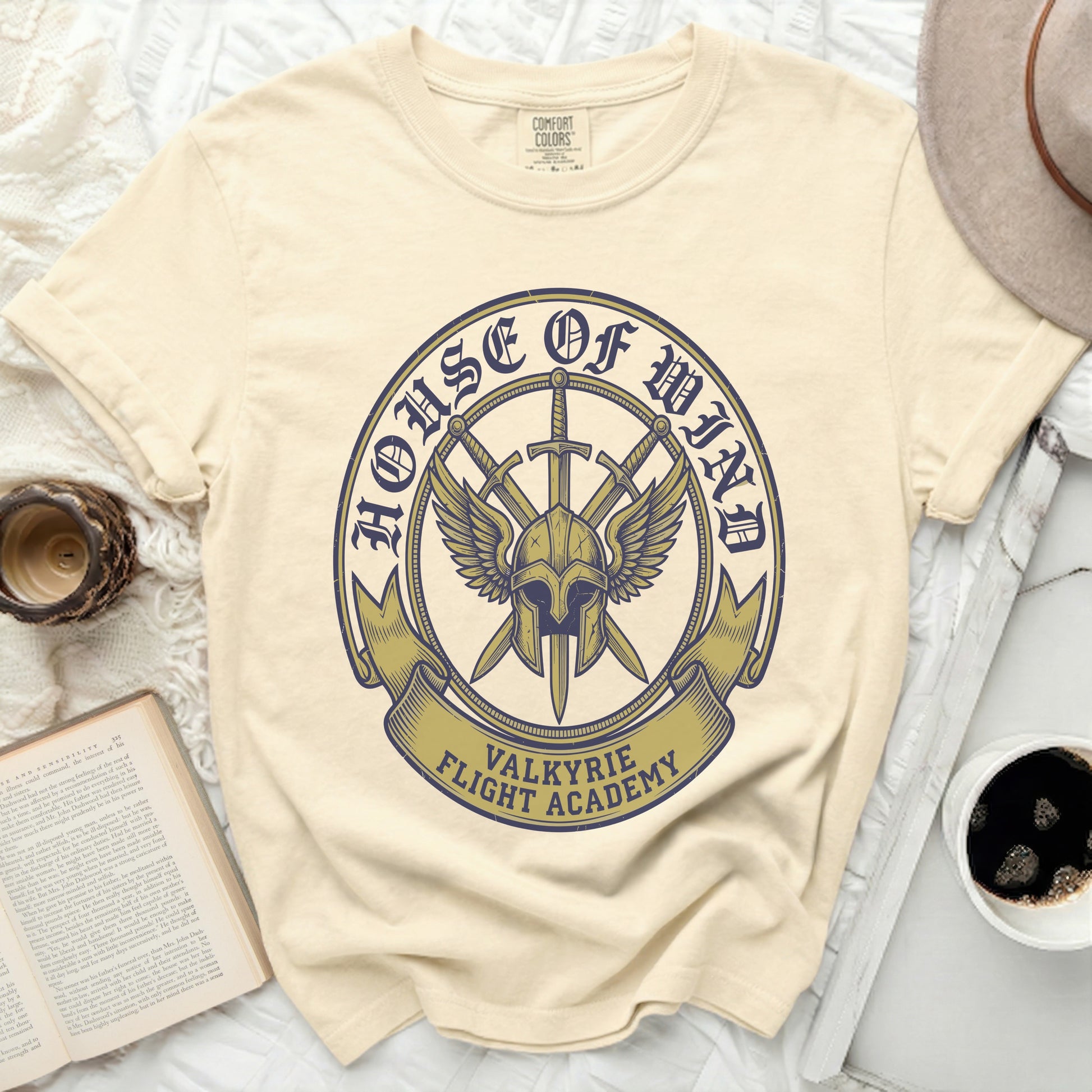 Cream t-shirt with "House of Wind Valkyrie Flight Academy" logo.