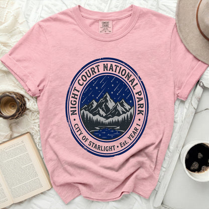 Pink t-shirt with "Night Court National Park City of Starlight Est. Year 1" circular graphic.
