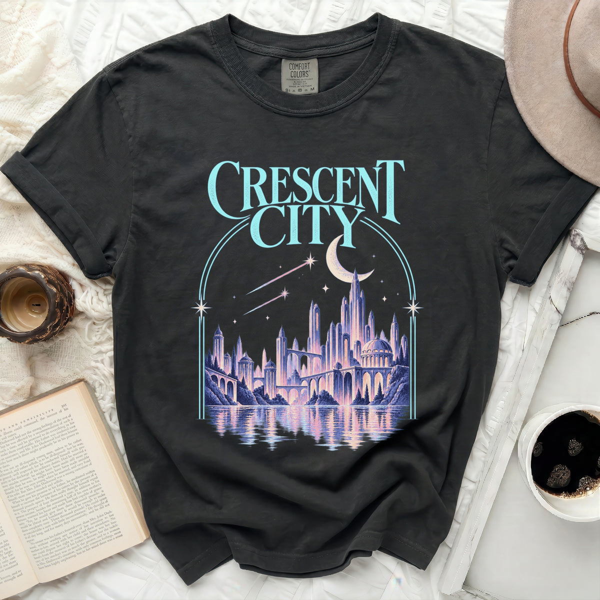 Dark t-shirt with "Crescent City" text and fantasy cityscape graphic.