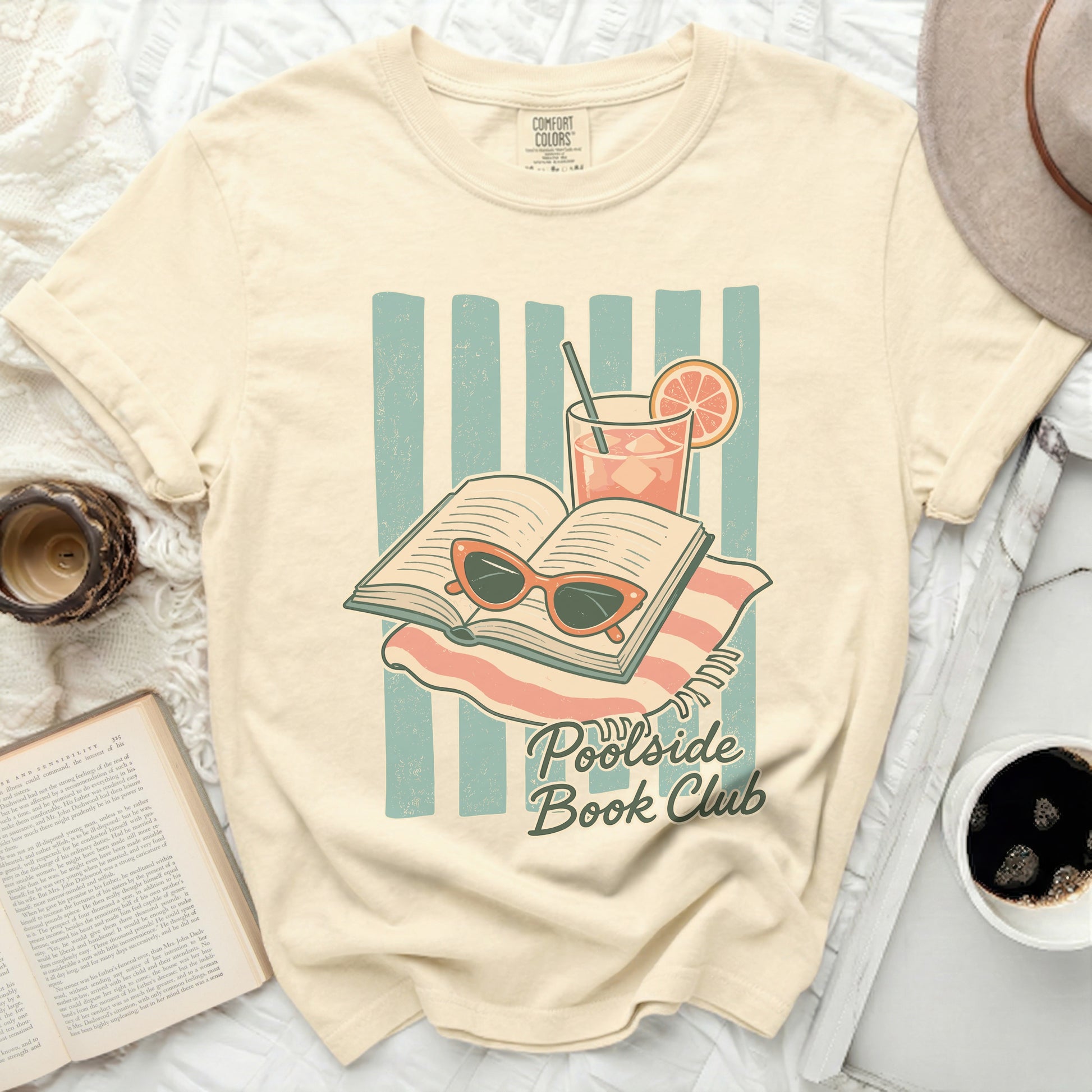 T-shirt with "Poolside Book Club" graphic of open book, sunglasses, and drink.