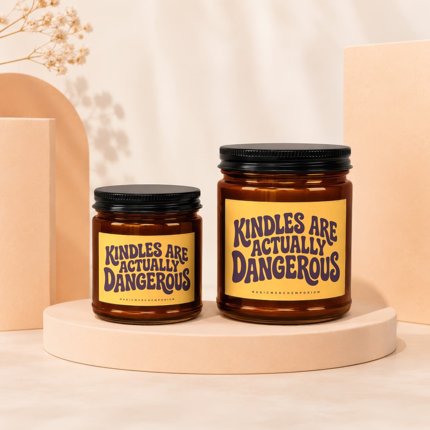 Two glass jars with black lids, one larger than the other, featuring text.