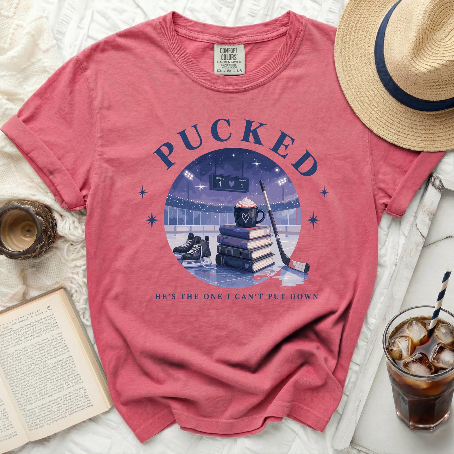 T-shirt with "Pucked" and hockey rink design, "He's the one I can't put down."
