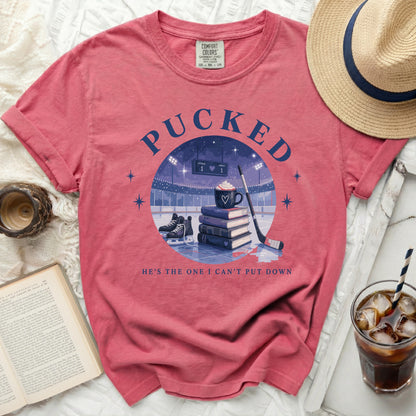 T-shirt with "Pucked" and hockey rink design, "He's the one I can't put down."